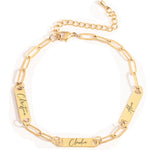 A gold-colored custom paper clip bracelet with a chain link design and personalized engraving on the chain.