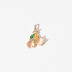 A gold-plated charm featuring a cherry design with pink stones and a small green gemstone accent.