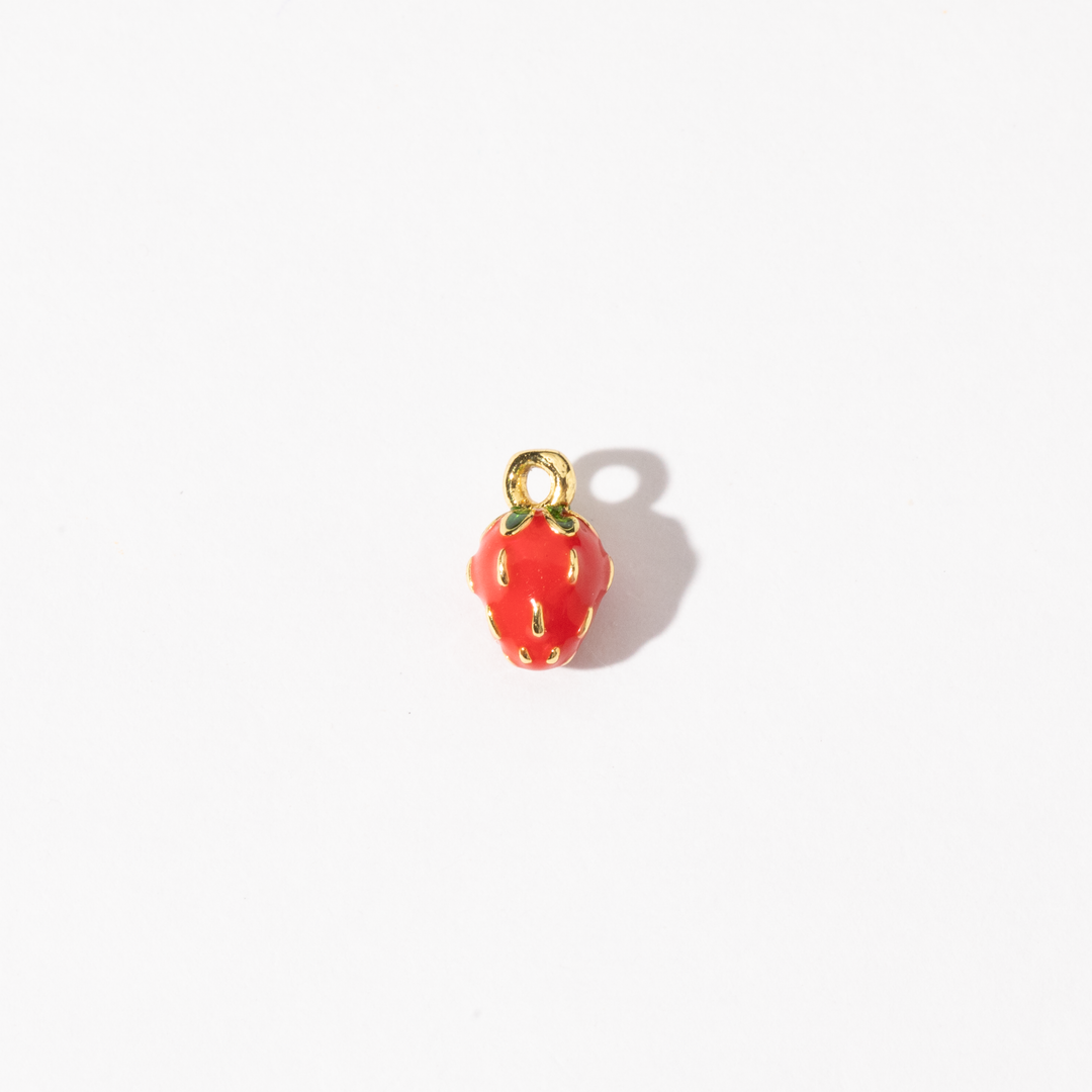 A gold-plated stainless steel charm with a vivid red finish, shaped like a strawberry with subtle details.
