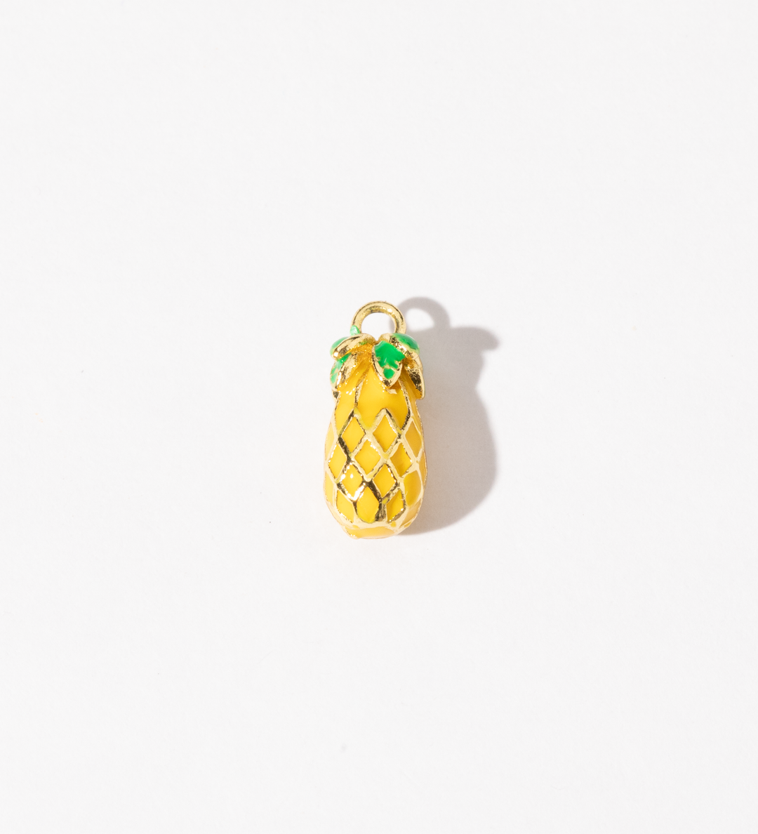 A gold-plated personalized stainless steel charm with a sculpted pineapple design, complete with delicate lattice detailing and bright green accents.