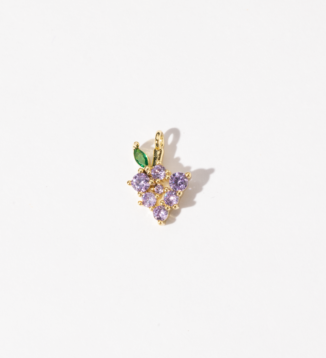 A customized gold plated stainless steel charm featuring a cluster of light purple zirconia stones with a green leaf accent.