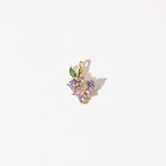 A customized gold plated stainless steel charm featuring a cluster of light purple zirconia stones with a green leaf accent.