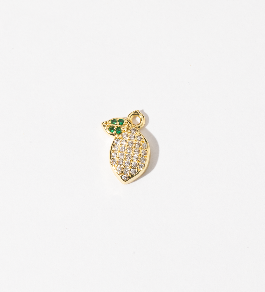 A Personalized gold-plated charm Jewelry in the shape of a lemon, adorned with clear zirconia stones and green gem leaves.