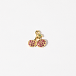 A custom made gold plated stainless steel charm in the shape of two cherries with red zirconia paving and a green gem leaf.