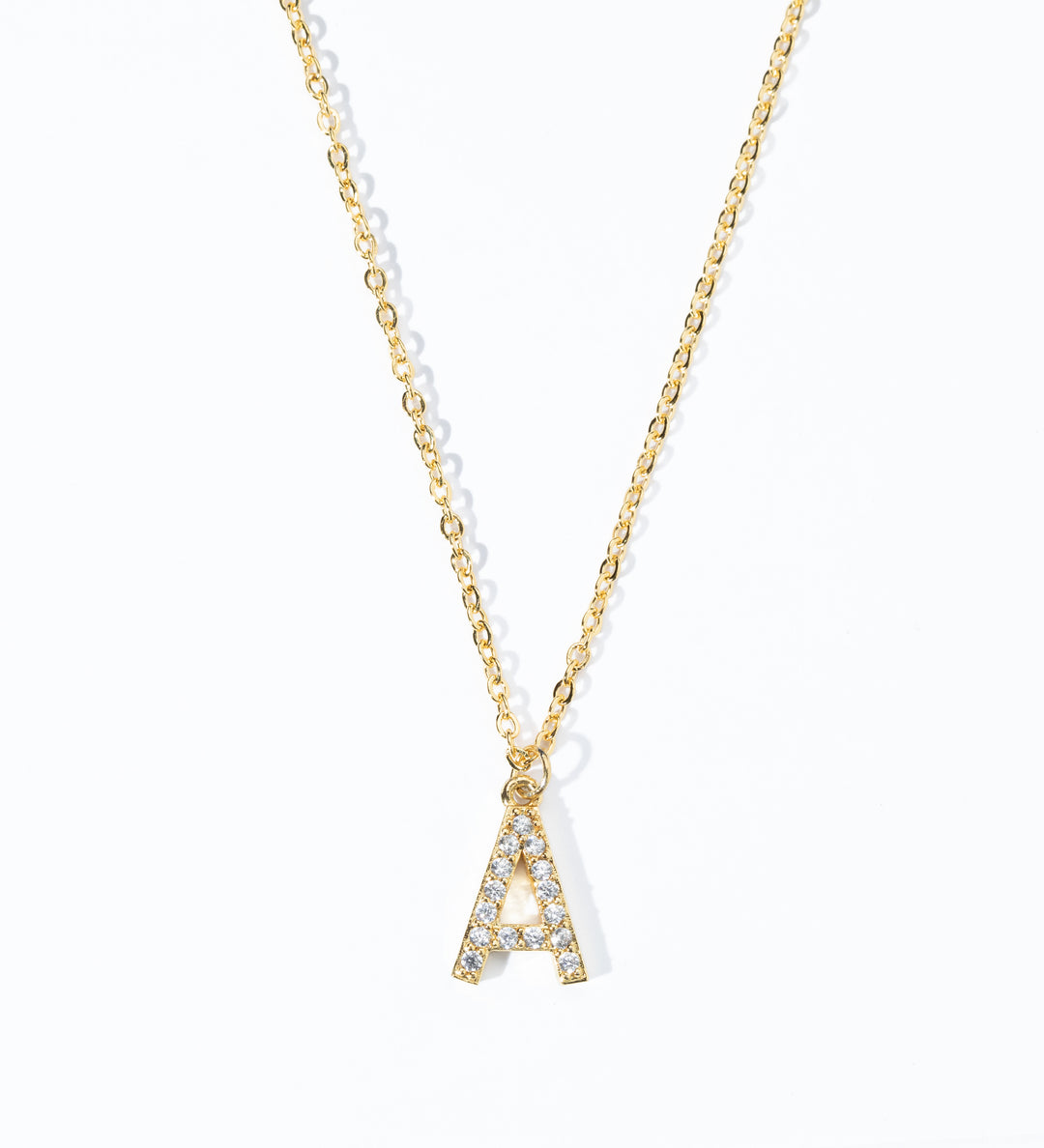 A gold-colored necklace with personalized initial displaying the necklace with a single letter 'A' pendant adorned with clear stones on a white background.