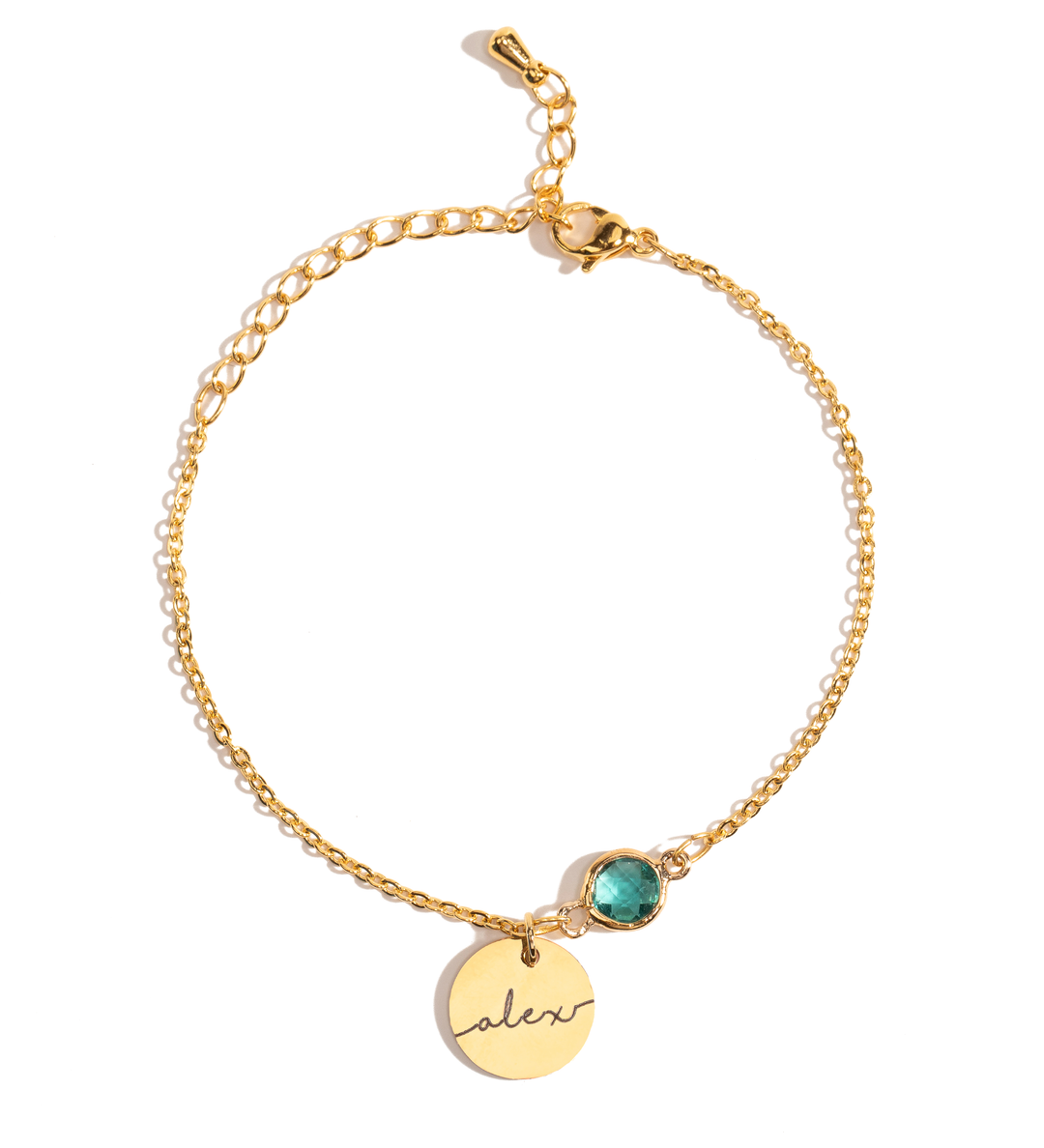 A gold-plated bracelet with a round birthstone charm and an engraved name coin charm on a white background.