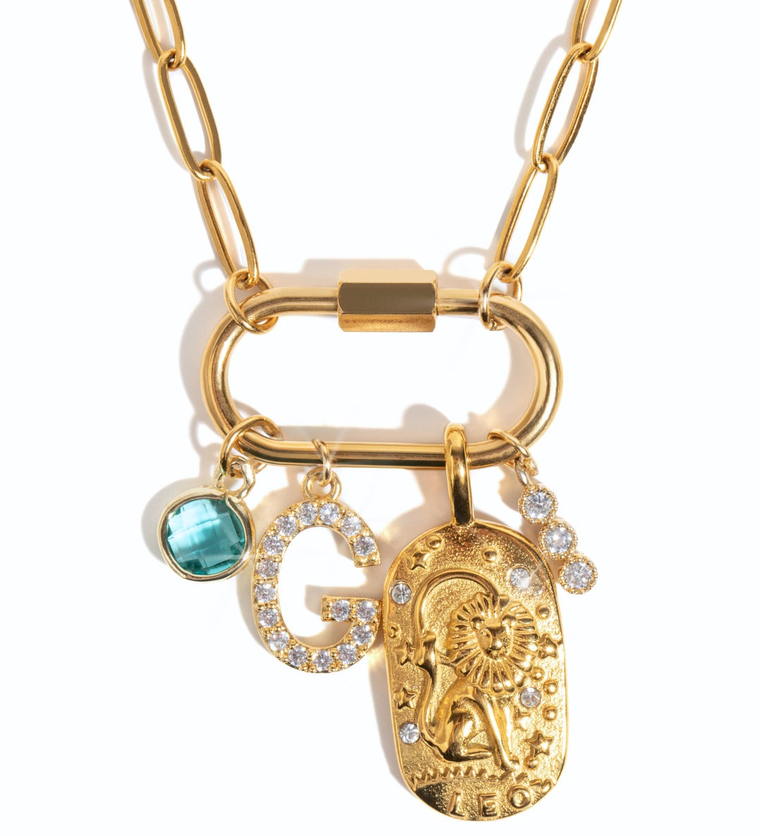 A gold-colored personlized carabiner necklace base with a link chain, a large carabiner clip, and three charms attached: a blue birthstone, a 'G' initial, and a gold-tone charm with intricate design.