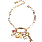 A personalized gold-colored personalized charm bracelet with a carabiner clasp, featuring various charms including a heart and a key.