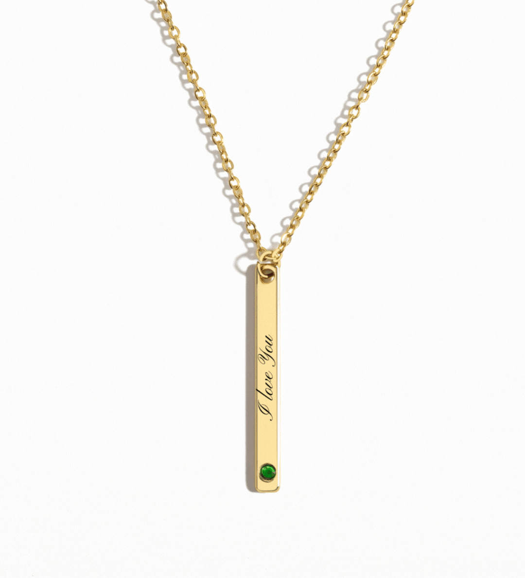Personalized gold vertical bar necklace featuring a custom engraving and a birthstone accent at the bottom, hanging from a delicate gold chain.