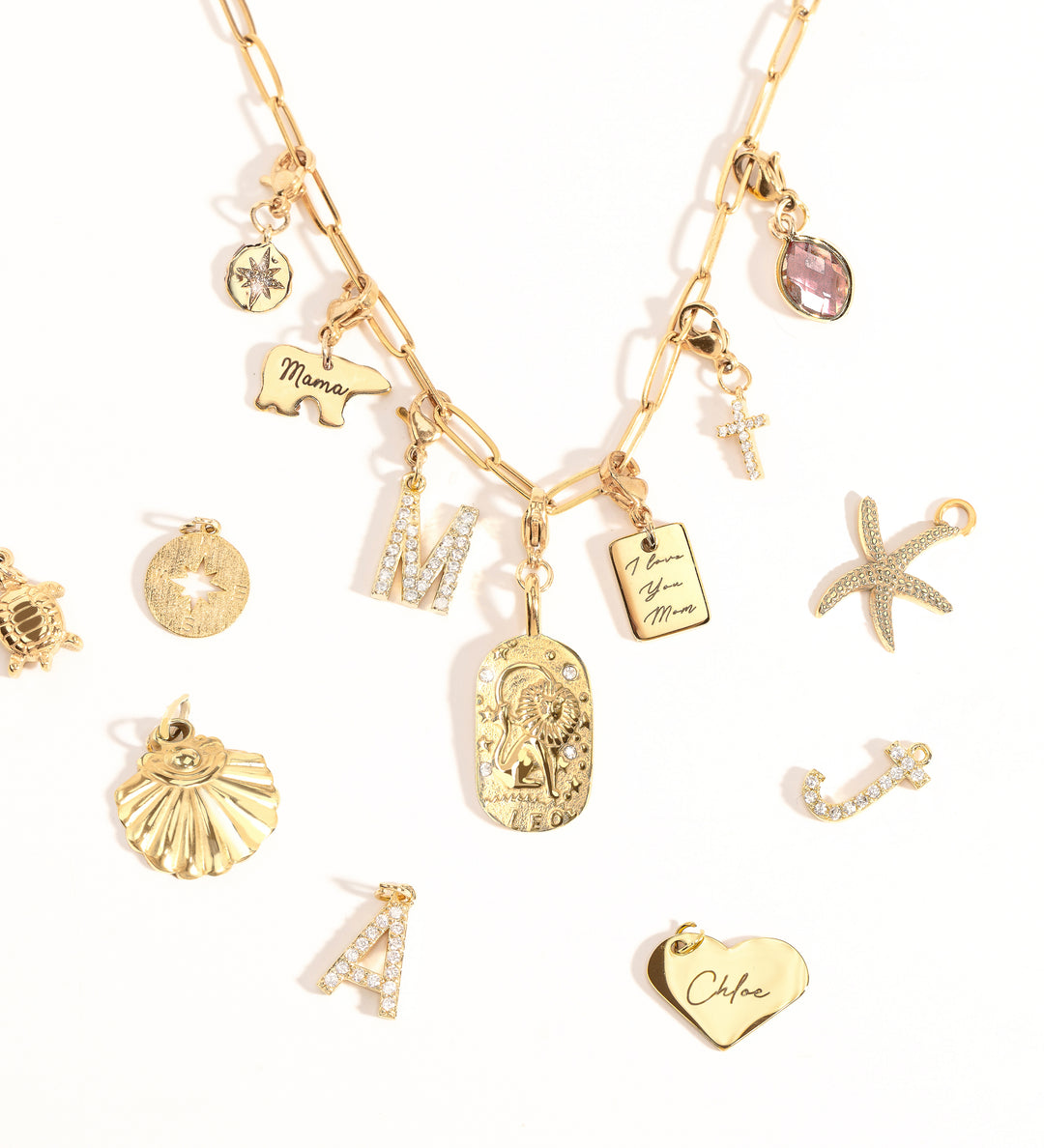 A collection of various charms including a heart, a star, and initial charms, attached to a gold-tone chain necklace.
