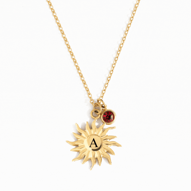 A personalized Necklace in the shape of the sun with engraved custom initial in the middle adorned with a birthstone